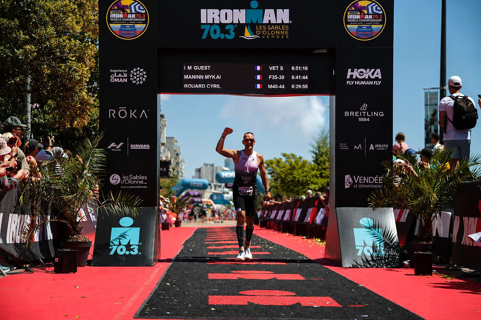 Tim crossing the finish line at Ironman 70.3 Les Sables d'Olonne